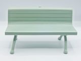 a green bench that is sitting on a white surface
