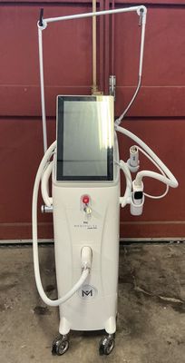 an image of a machine that is sitting in front of a red wall