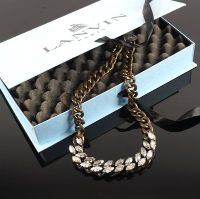 a close up of a box with a necklace in it on a table