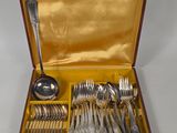 a box with silverware in it on a white surface