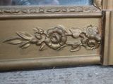 a close up of a gold door with flowers on it