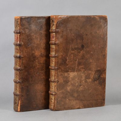 an old book sitting on top of a table next to another book
