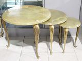 three tables that are sitting on a tiled floor