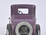 a small purple toy car sitting on a white surface