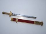 two knives are sitting on top of each other on a white surface