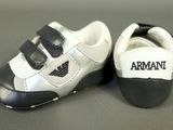 pair of black and white sneakers with armani logo on them