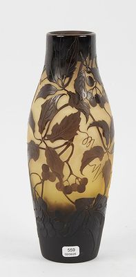 a black and yellow vase sitting on a white surface