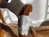 a wooden chair with a piece of paper on the seat