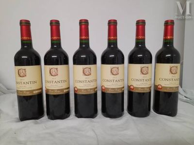 six bottles of wine are lined up on a table