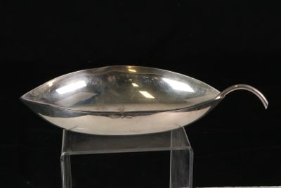 a silver bowl on a clear stand on a black background