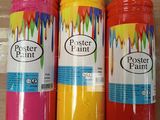 three bottles of paint are sitting on a cardboard box