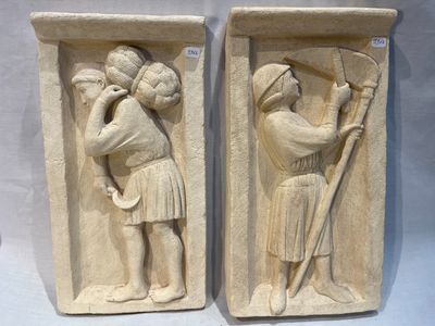 une paire de bas-reliefs en pierre représentant un homme et une femme tenant un bâton