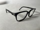 a pair of glasses sitting on a white surface