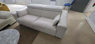 a white couch and a chair in a living room