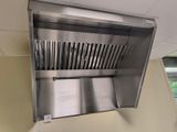 a stainless steel exhaust hood mounted on the wall