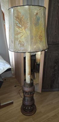 a lamp that is sitting on the floor in front of a mirror