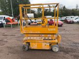 a yellow scissor that is parked in the dirt