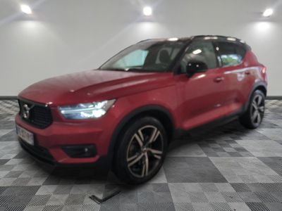 the red volvo suv is parked on a checkered tile floor