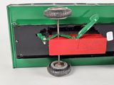 a green and red toy truck with wheels and a red box