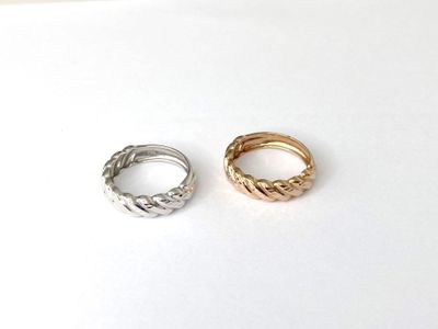 a couple of rings sitting on top of a white surface