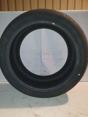 a close up of a tire on a table with a white background