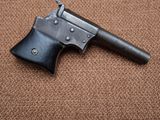 a close up of a gun on a carpeted surface