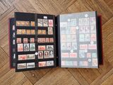 a book with stamps on it sitting on a wooden floor
