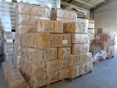 a large stack of boxes sitting on a pallet in a warehouse