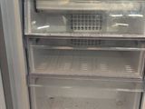 an empty refrigerator with the door open in a kitchen