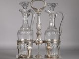 trois vases en verre posés sur un socle en argent