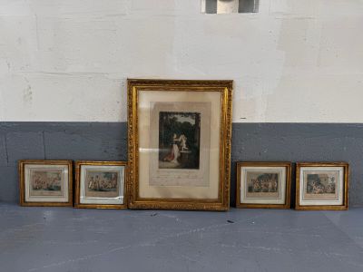 quatre photos encadrées posées par terre près d'un mur