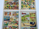 four different comics are displayed on a wall in a room