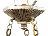 a silver chandelier hanging from a chain with a hook