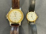 an image of a couple of watches sitting on top of a table