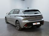 the rear end of a silver car in a white room