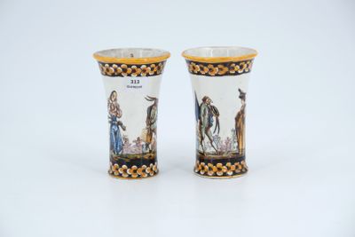pair of porcelain vases with figures on them on a white surface