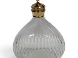 an image of a clear glass bottle with a gold top