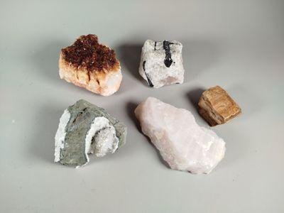 five different types of rocks on a white surface