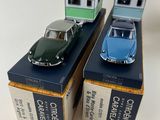 three toy cars are sitting in boxes on a white surface
