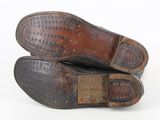 pair of brown leather shoes with rivets and studs on the sole