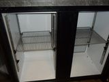 two open refrigerators that are sitting in a kitchen