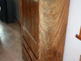 a tall wooden cabinet in the corner of a room