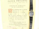 a watch sitting on top of a piece of paper