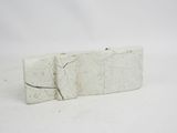 a white stone block with a crack in it on a white surface