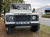 a white land rover parked on the side of the road