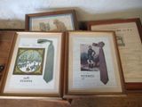 three framed pictures of men ' s ties on a shelf