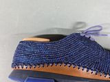 the shoe is blue and brown with a brown sole