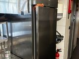 a stainless steel refrigerator in a kitchen with a counter top