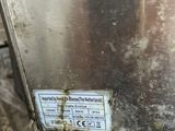 a close up of a metal object on the side of a building