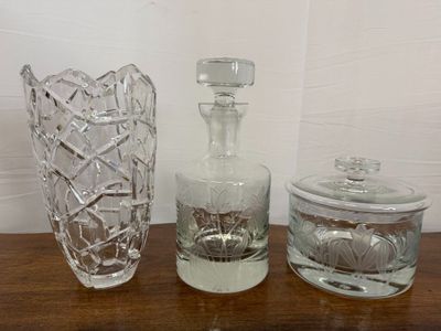 three glass vases sitting on a table next to each other
